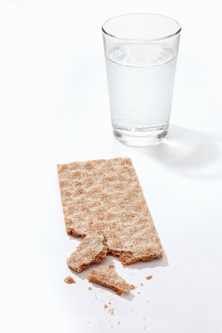 A crispbread and a glass of water