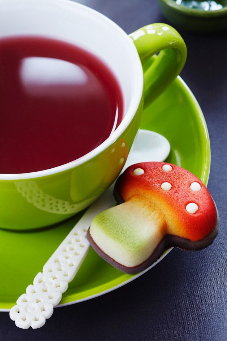 A marzipan toadstool with a cup of tea