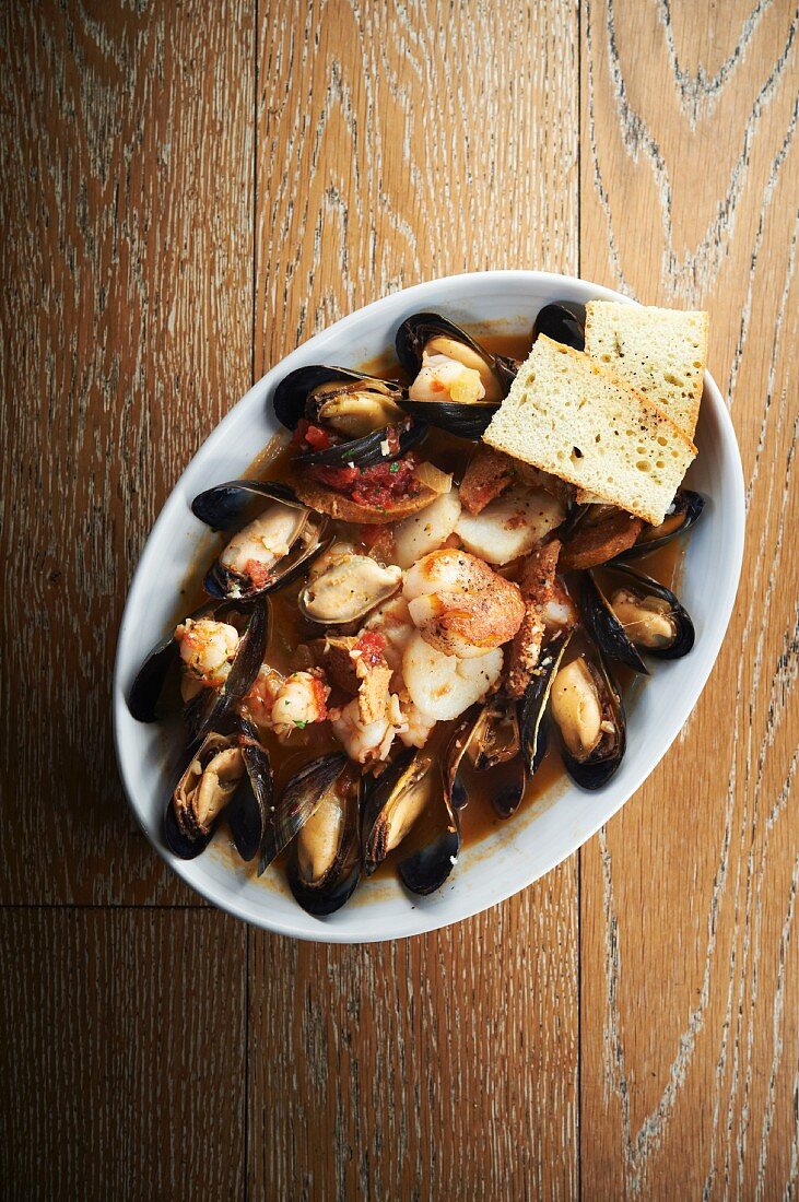 Mussels, chorizo and scallops in a white wine and saffron broth served with foccacia