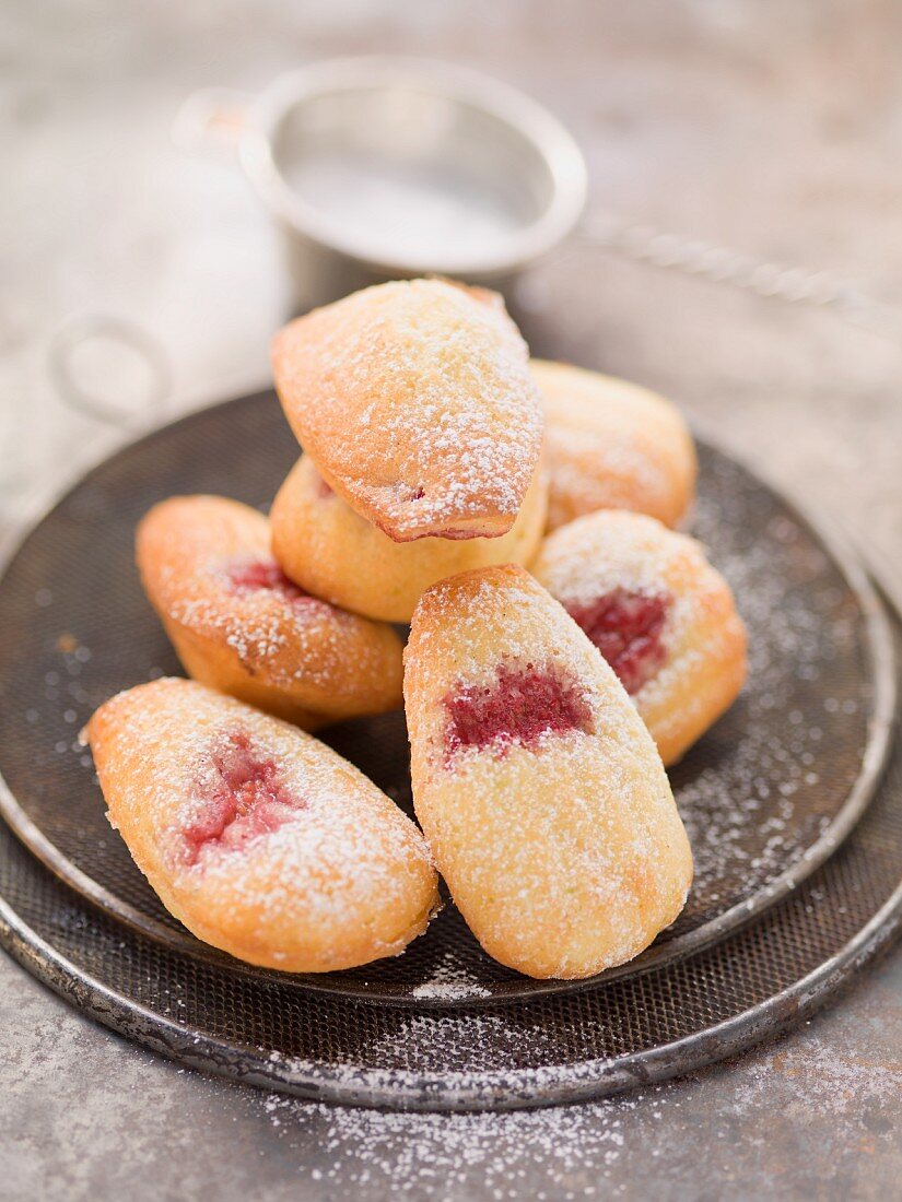 Madeleines with raspberry jam and icing sugar