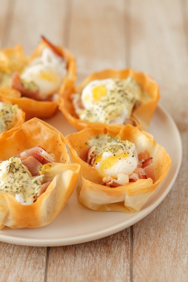 Filo pastry cases filled with prosciutto, quail's eggs and hollandaise sauce