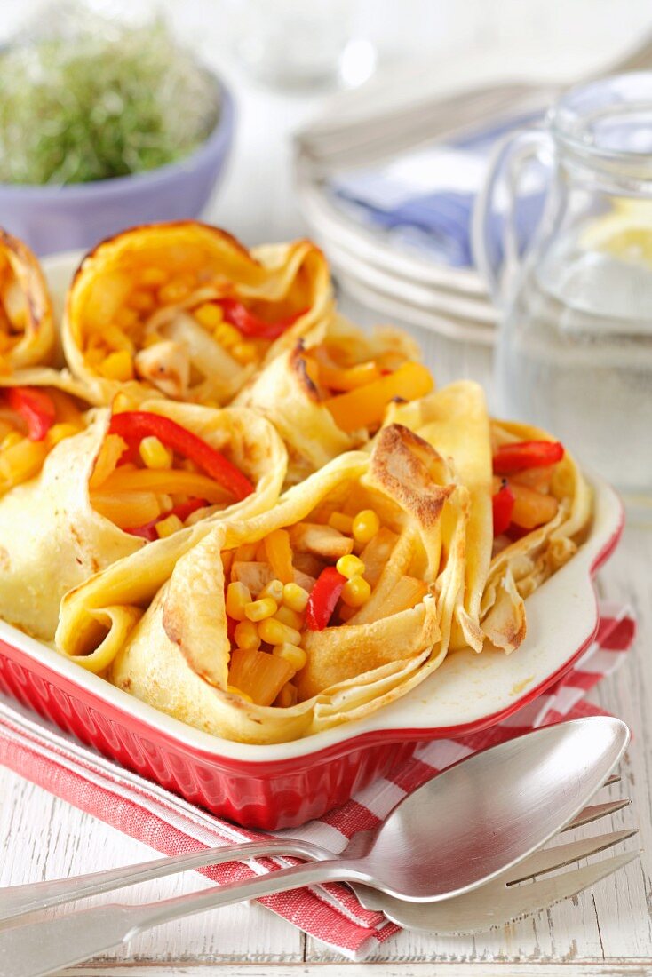 Pancakes filled with chicken, peppers and pineapple in garlic sauce