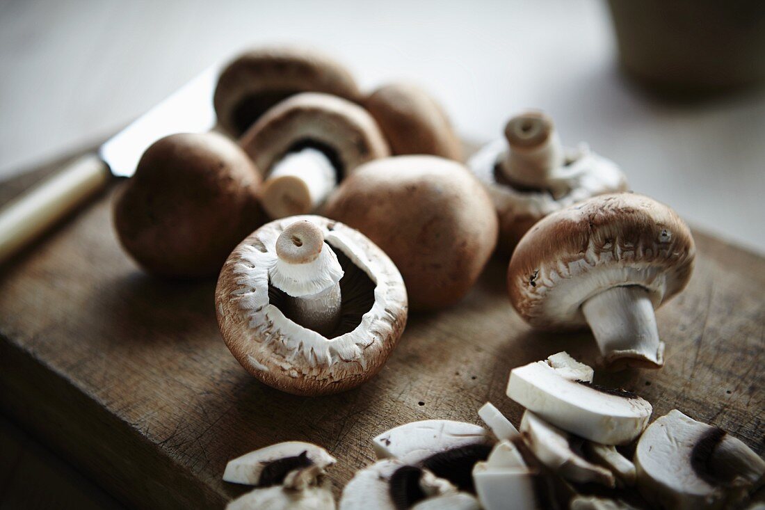 Button mushrooms on a wooden board