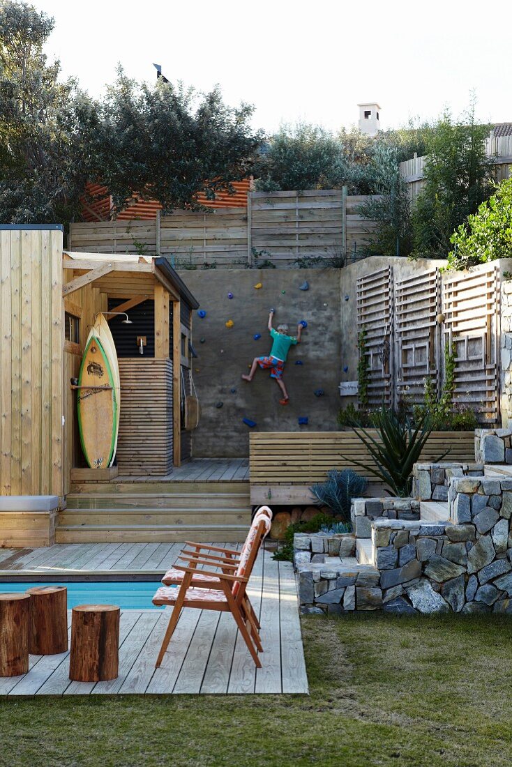 Recreation area with pool and climbing wall in private garden