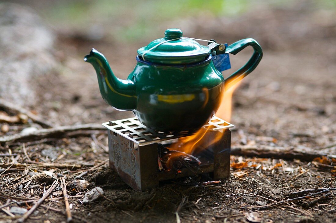 Tea being made on a small metal oven