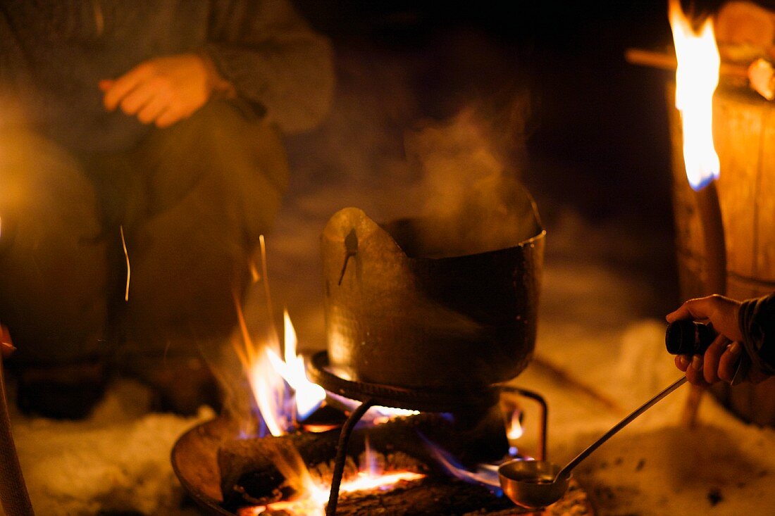 Brandy punch being made on an open fire