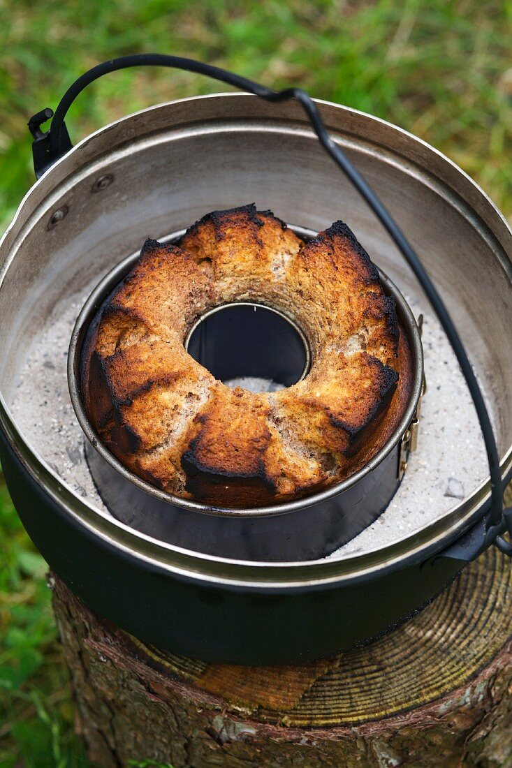 A Bundt cake baked over an open fire