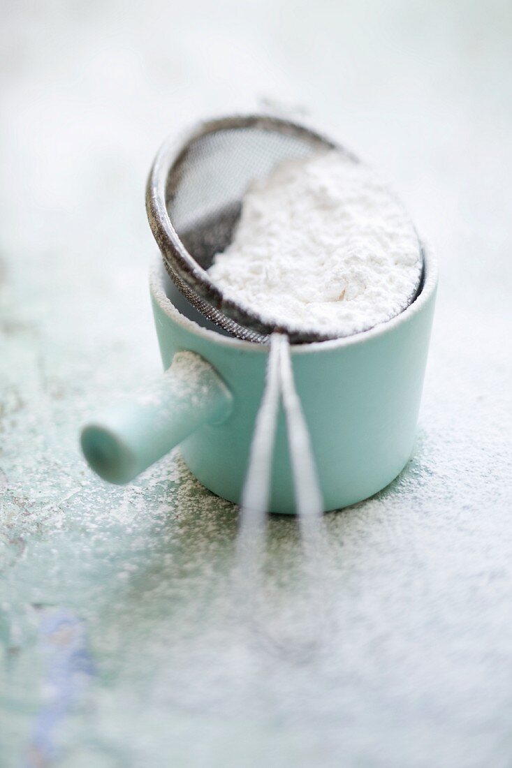 Icing sugar in a sieve