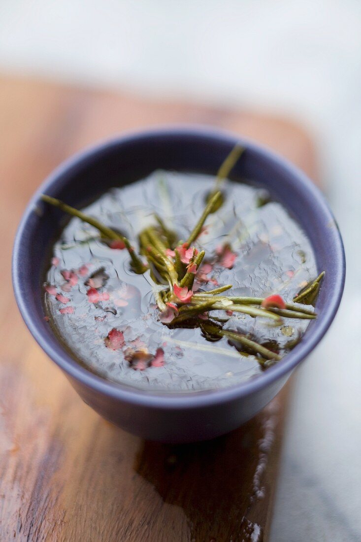 Orange and honey flavoured soy sauce with rosemary in a small bowl