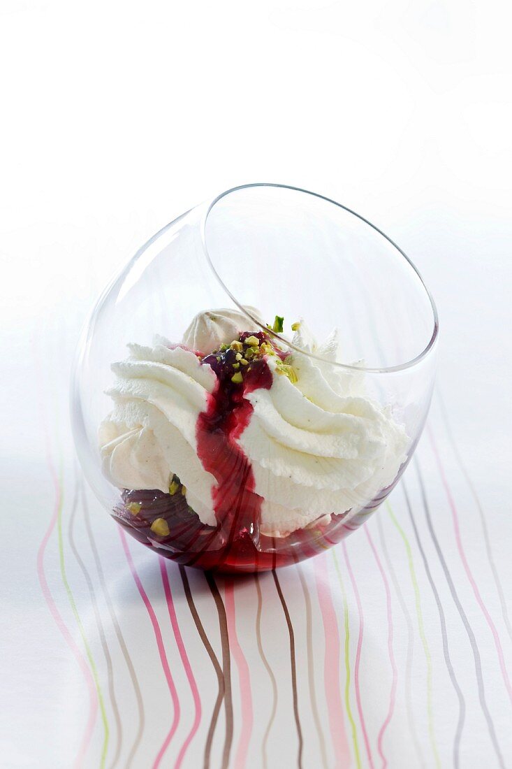 Meringue and cream with blackcurrant and pistachios