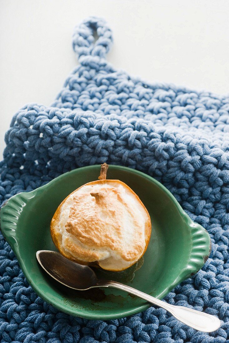 A baked pear with coconut meringue