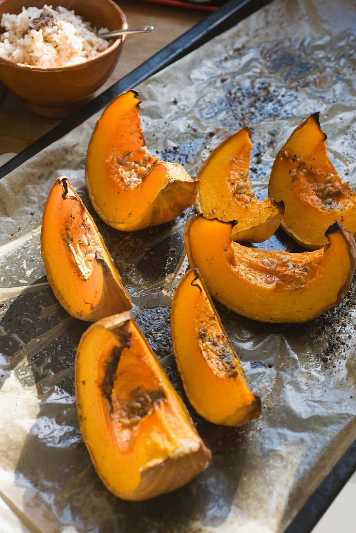 Baked wedges of squash with seasoning salt, served with rice