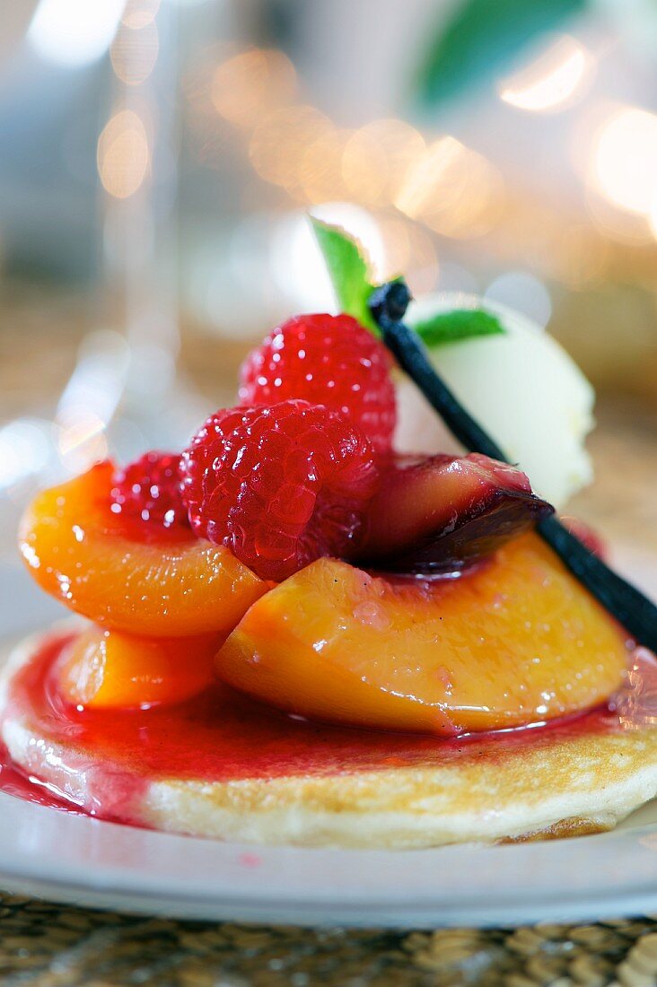 Pancakes with peaches, raspberries and lemongrass (close-up)