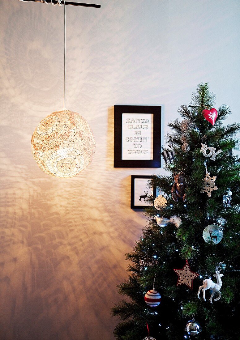 Lampshade hand-crafted from doilies and festive motifs on wall