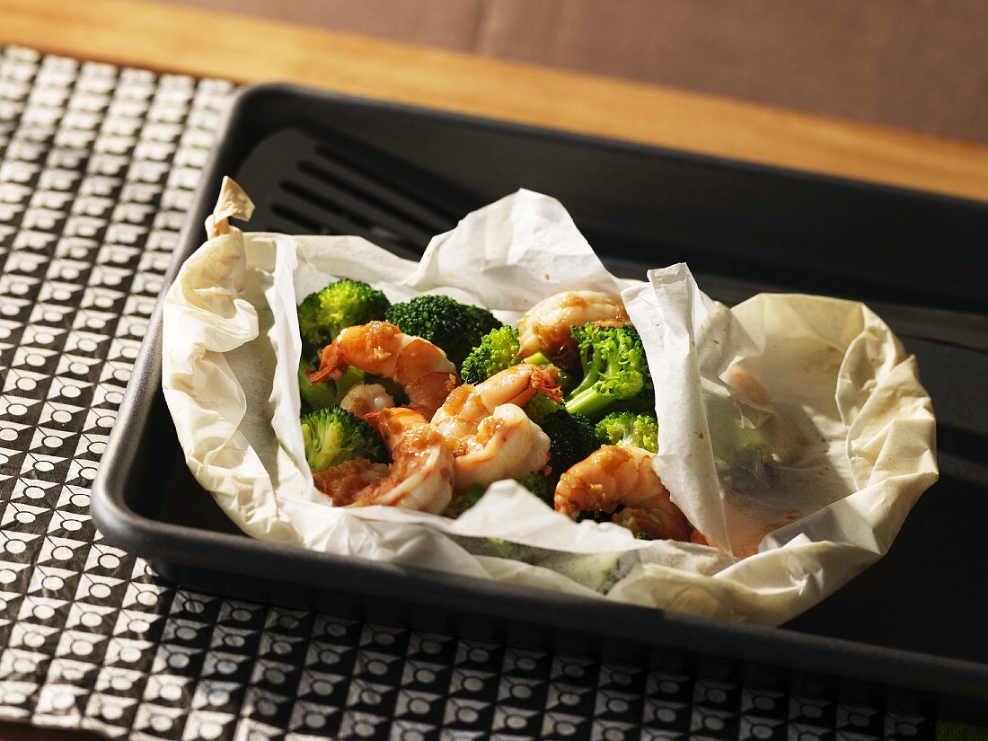 Prawns with broccoli florets wrapped in grease-proof paper