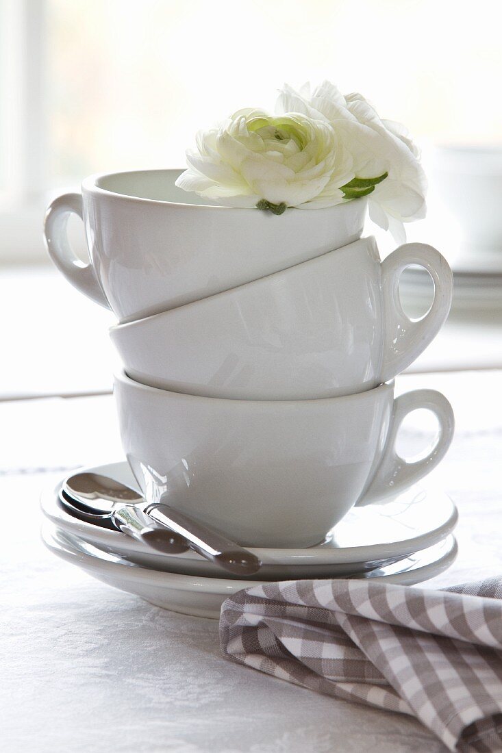 Stacked coffee cups decorated with white flowers