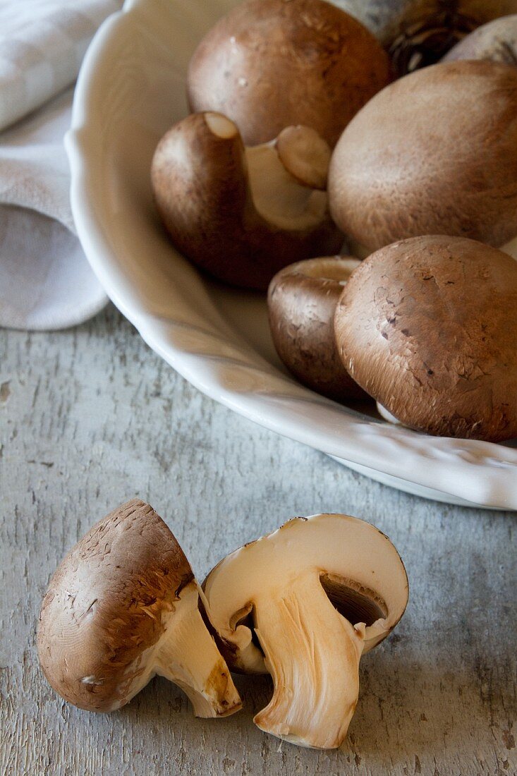 Chestnut mushrooms in a white porcelain bowl