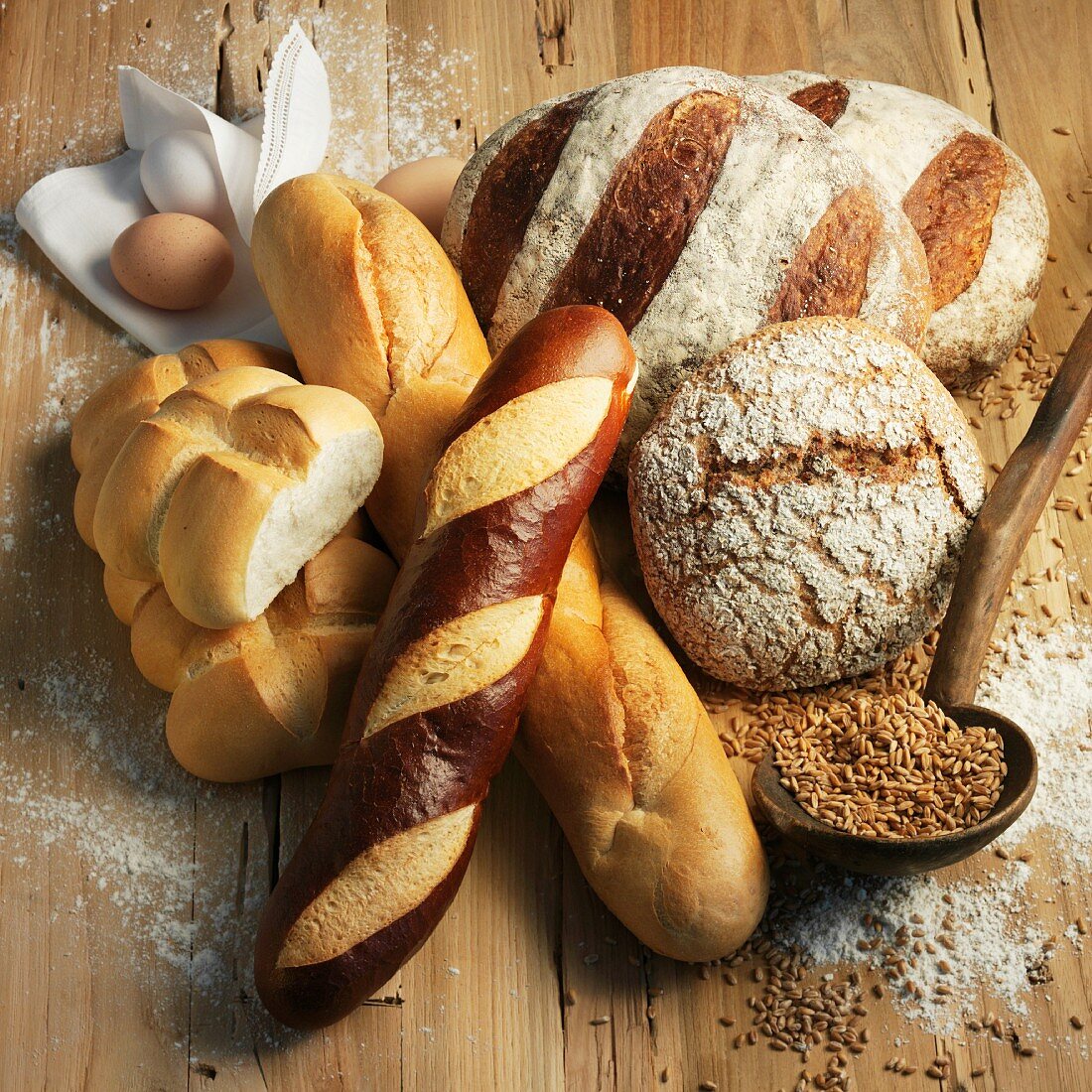 Assorted types of bread on a wooden surface