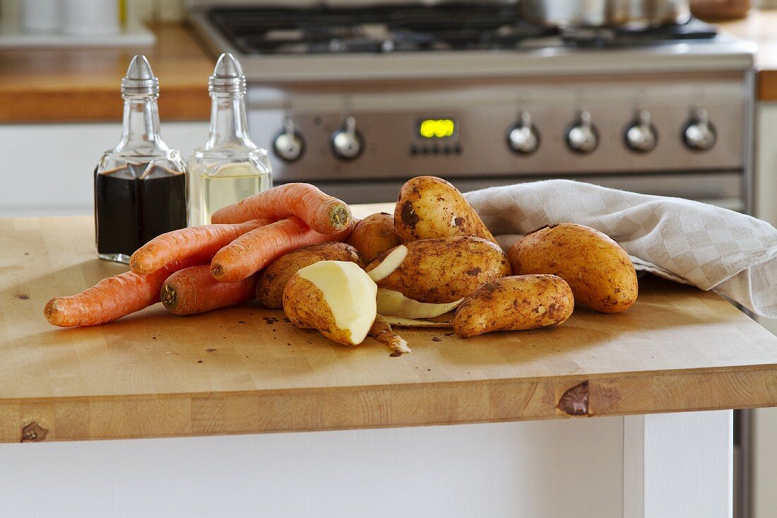 Potatoes and carrots on the work surface