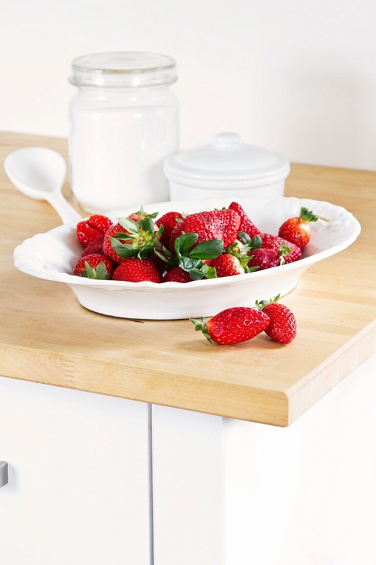 Fresh strawberries in a white porcelain bowl