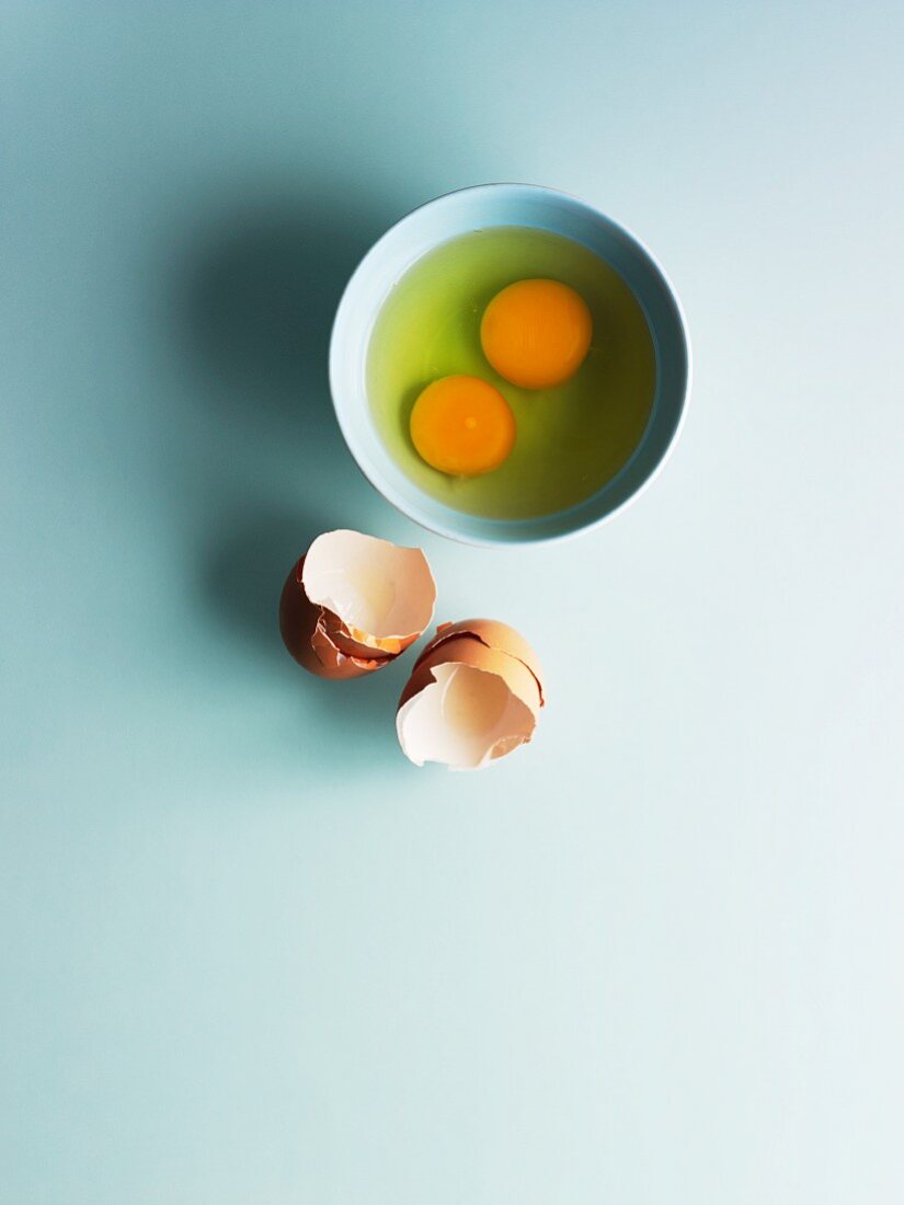Two shelled eggs in a bowl