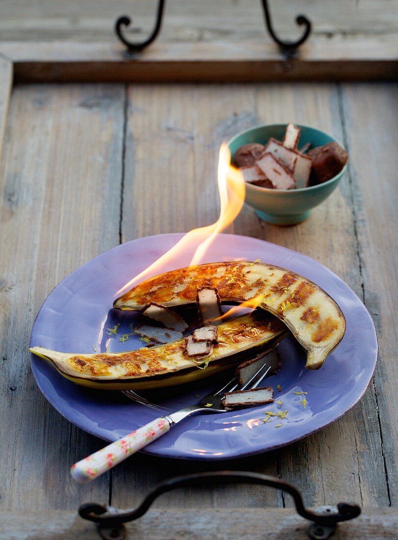 A flambéed banana with frozen chocolate-covered coconut