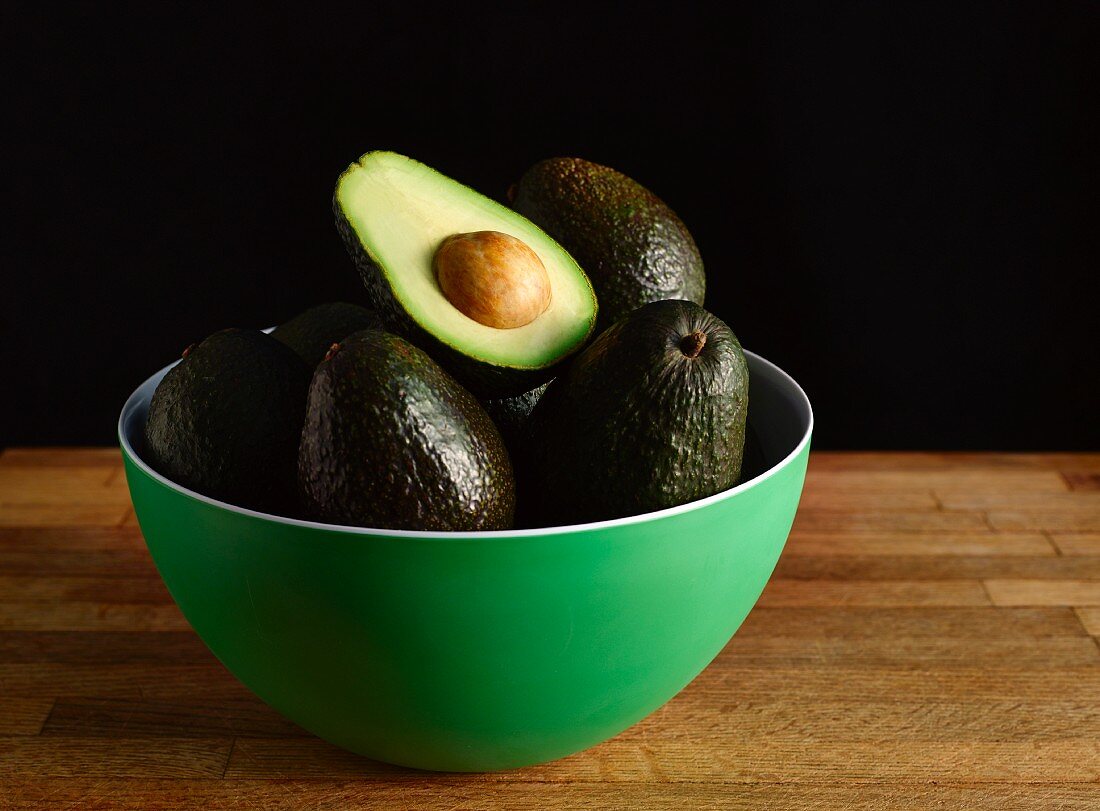 Avocados in a Green Bowl; One Halved