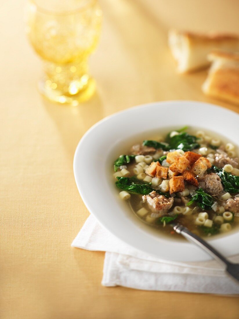 Pasta soup with sausage and croutons