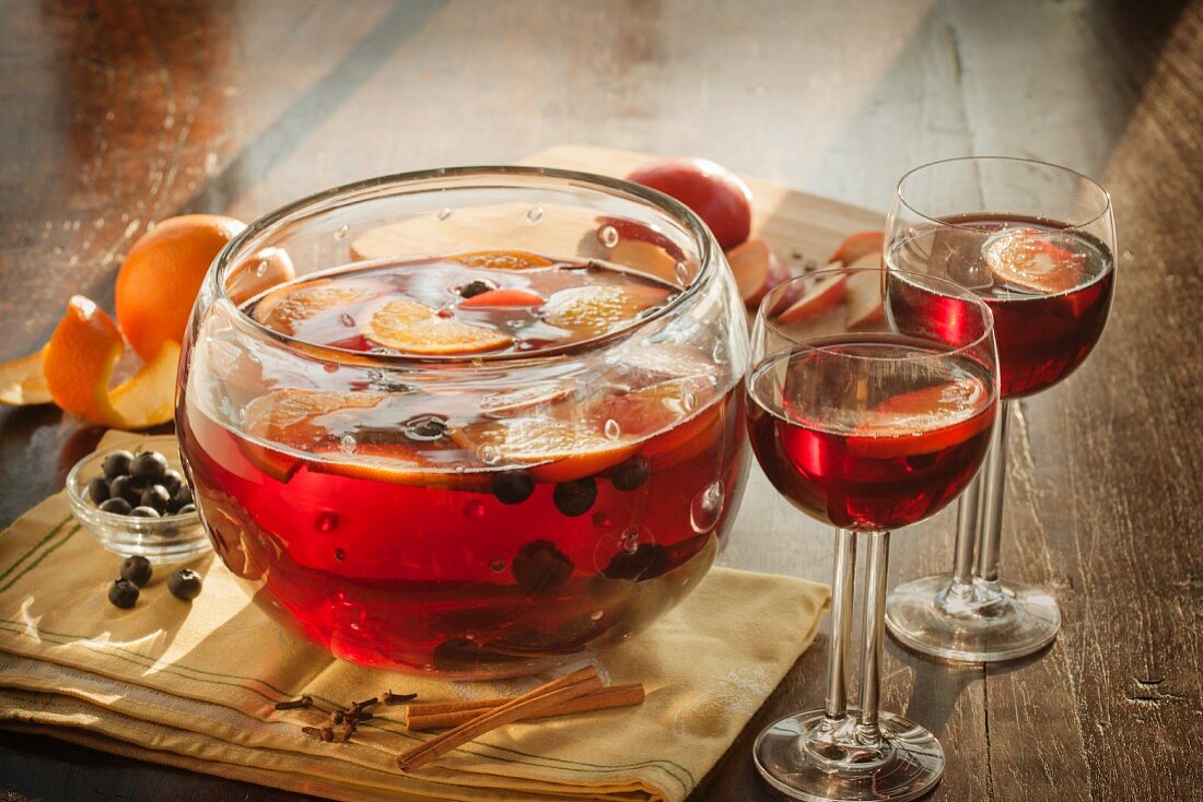 Fruity Punch with Cinnamon Sticks in a Punch Bowl and Glasses