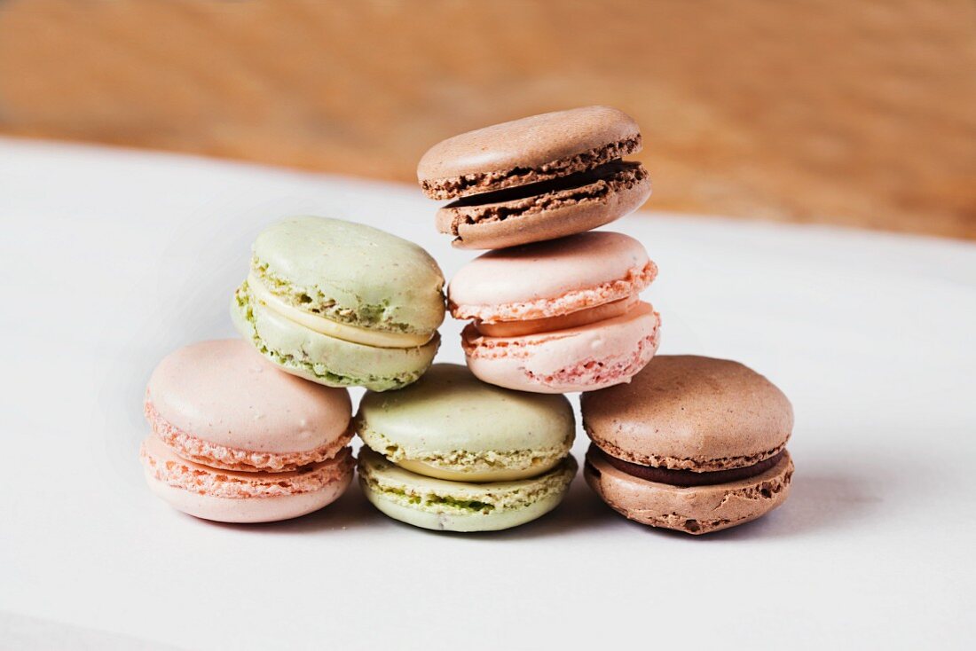 Assorted Macaroons Stacked on Wax Paper