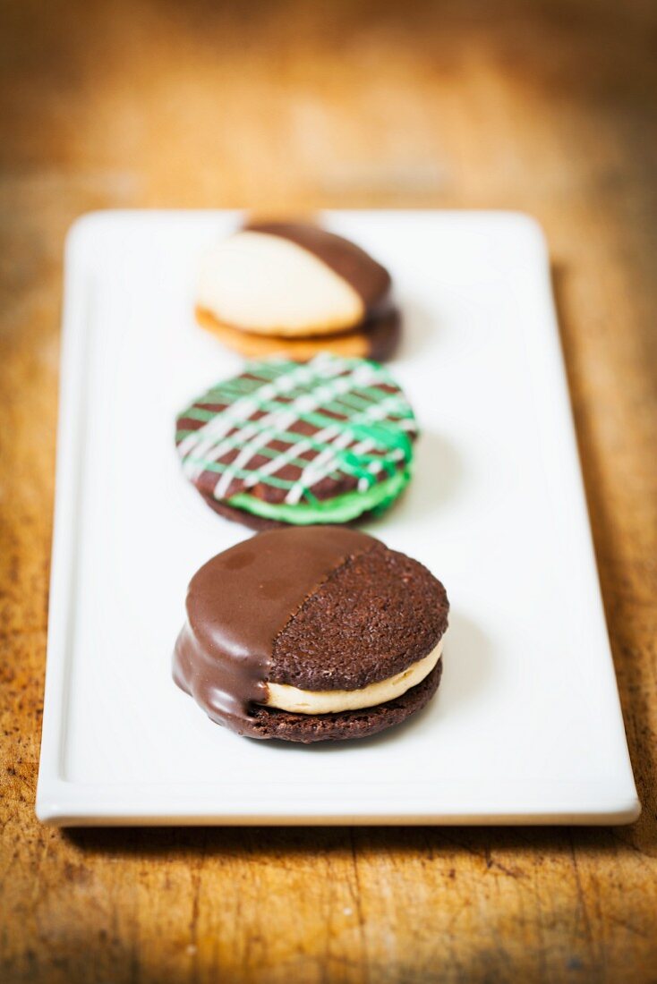 Three Assorted Sandwich Cookies on a White Platter