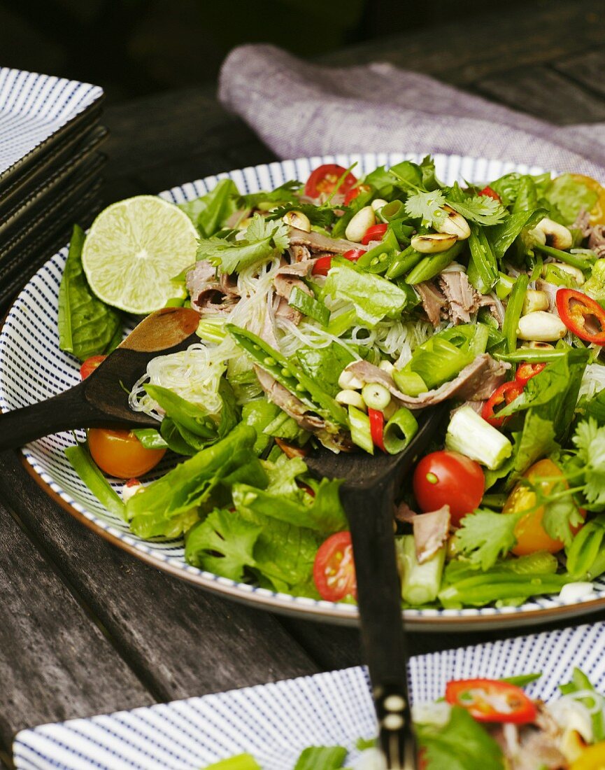 A salad of fine rice noodles with vegetables and limes (Thailand)