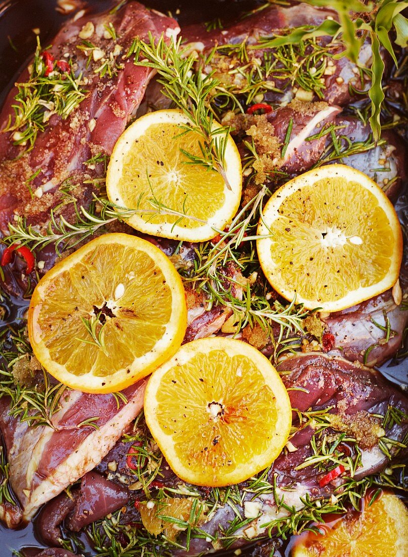 Marinated duck breast with oranges, rosemary, chilli, honey and garlic (close-up)