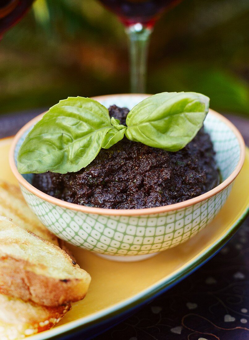 Tapenade with a sprig of basil