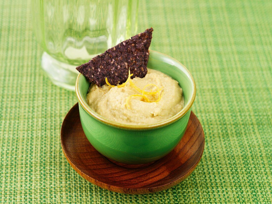 Houmous with a black tortilla chip
