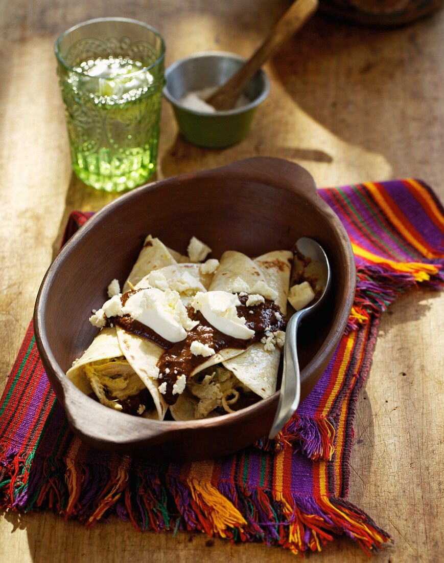 Enchiladas with chocolate sauce and curd cheese