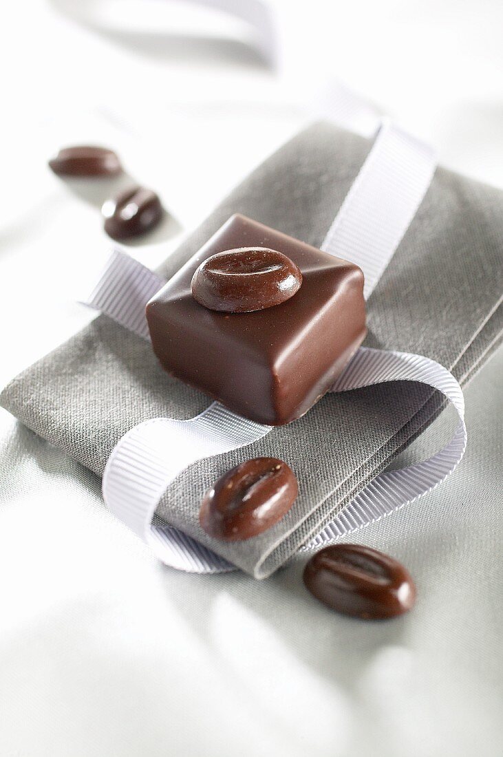 A mocha chocolate on a napkin with a ribbon