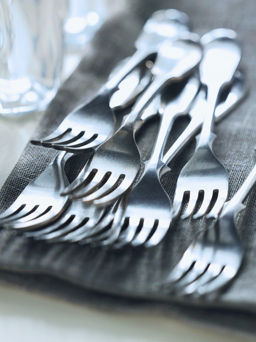 Lots of forks on a linen cloth