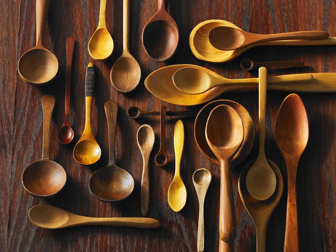 Assorted wooden spoons on a wooden surface