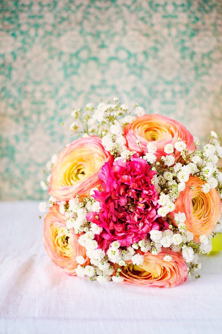 Spring posy with ranunculus and gypsophila next to old books