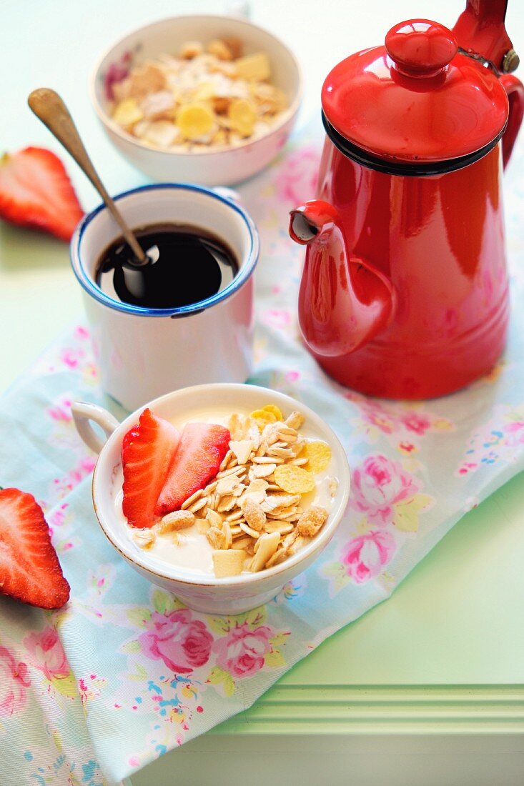 Muesli with strawberries, a cup of coffee