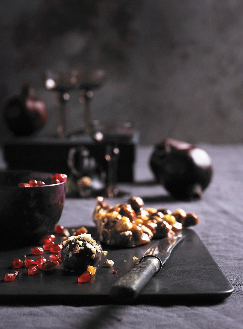 Chocolate truffles, pomegranate seeds and hazelnut brittle