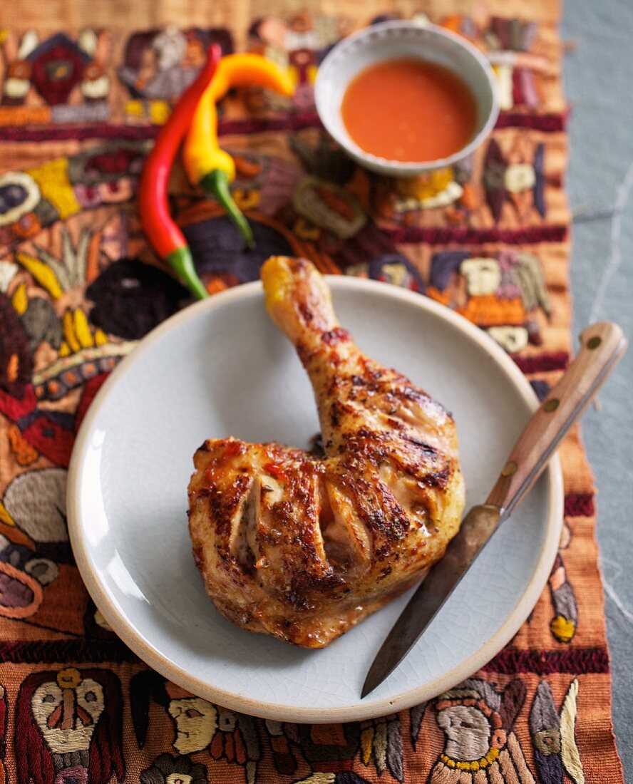 Barbecued chicken leg with spicy chilli sauce