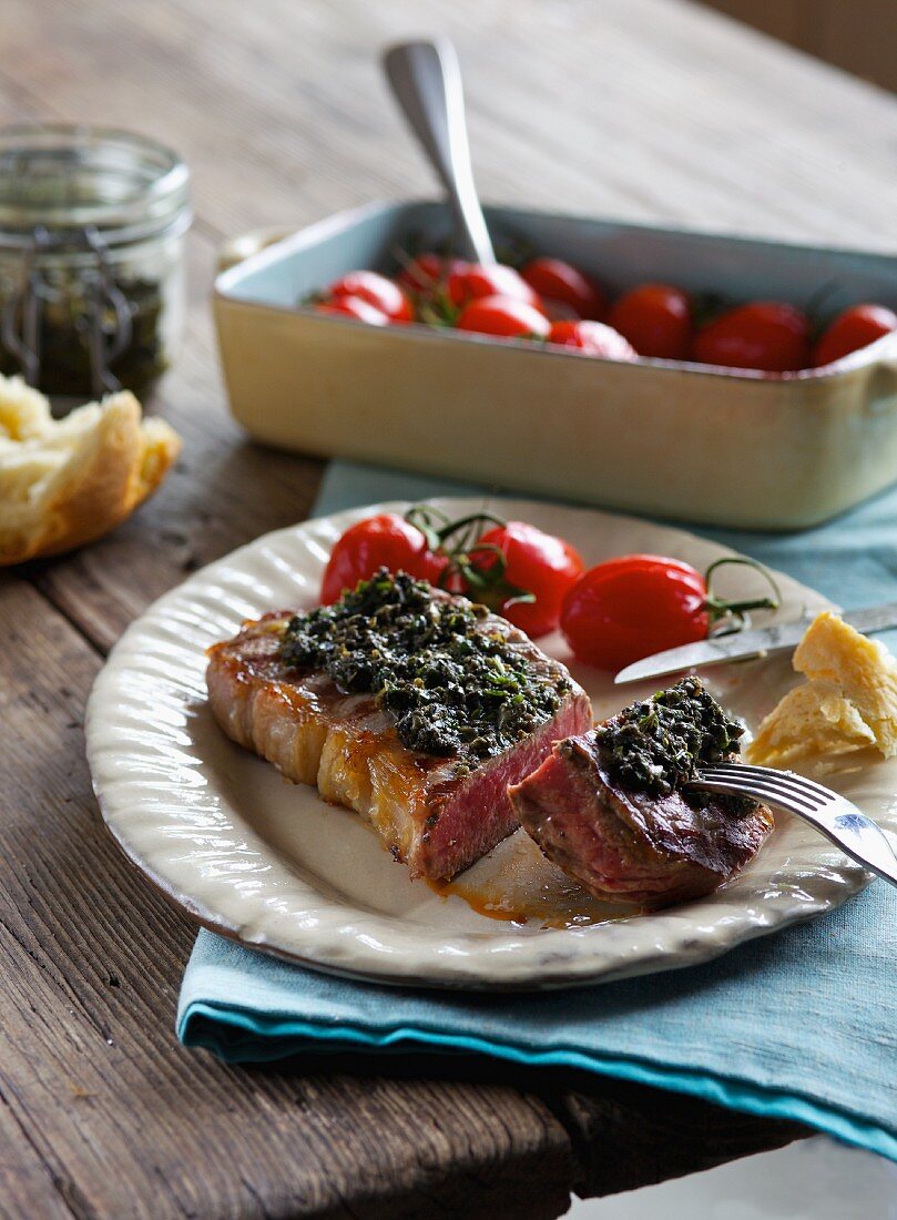 Barbecued beef steak with tapenade and tomatoes