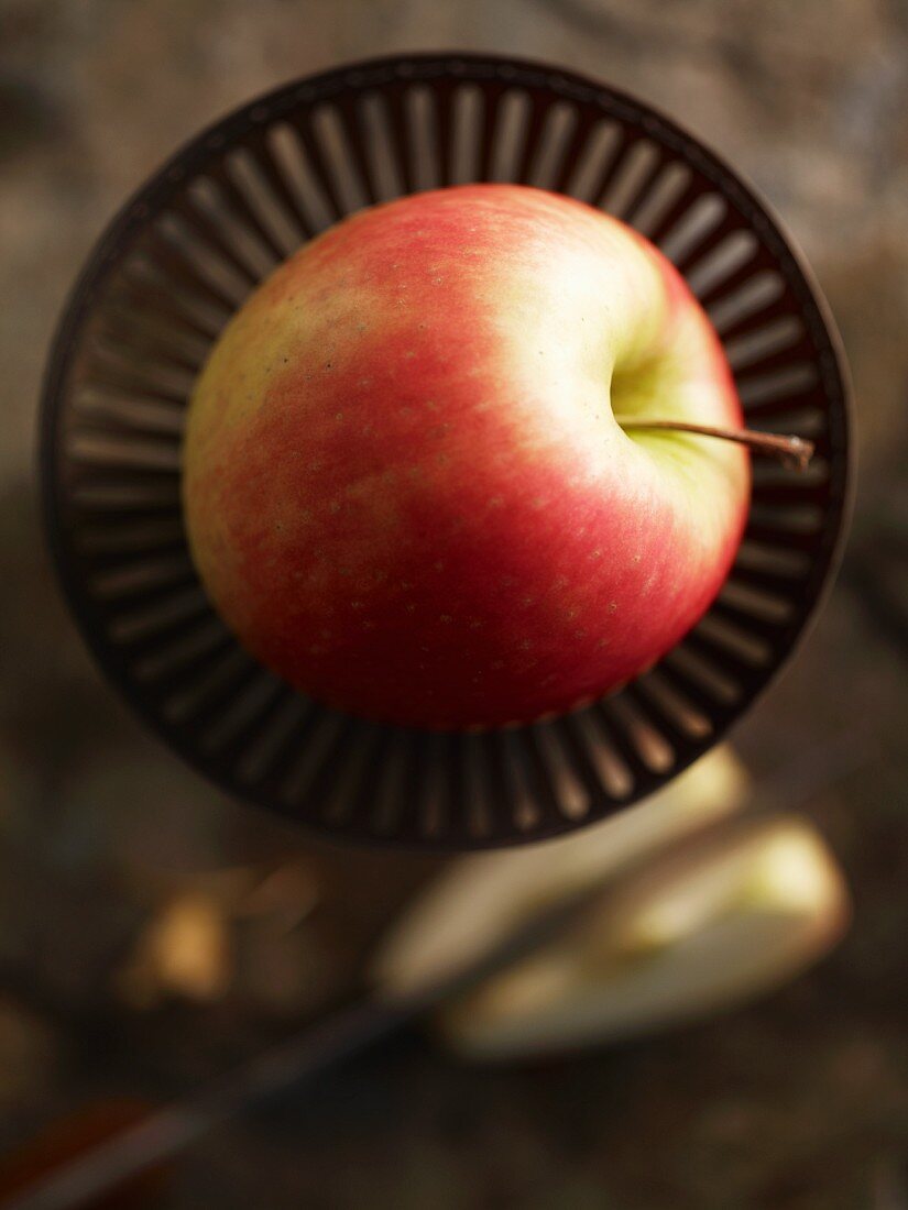 A Pink Lady apple in a dish