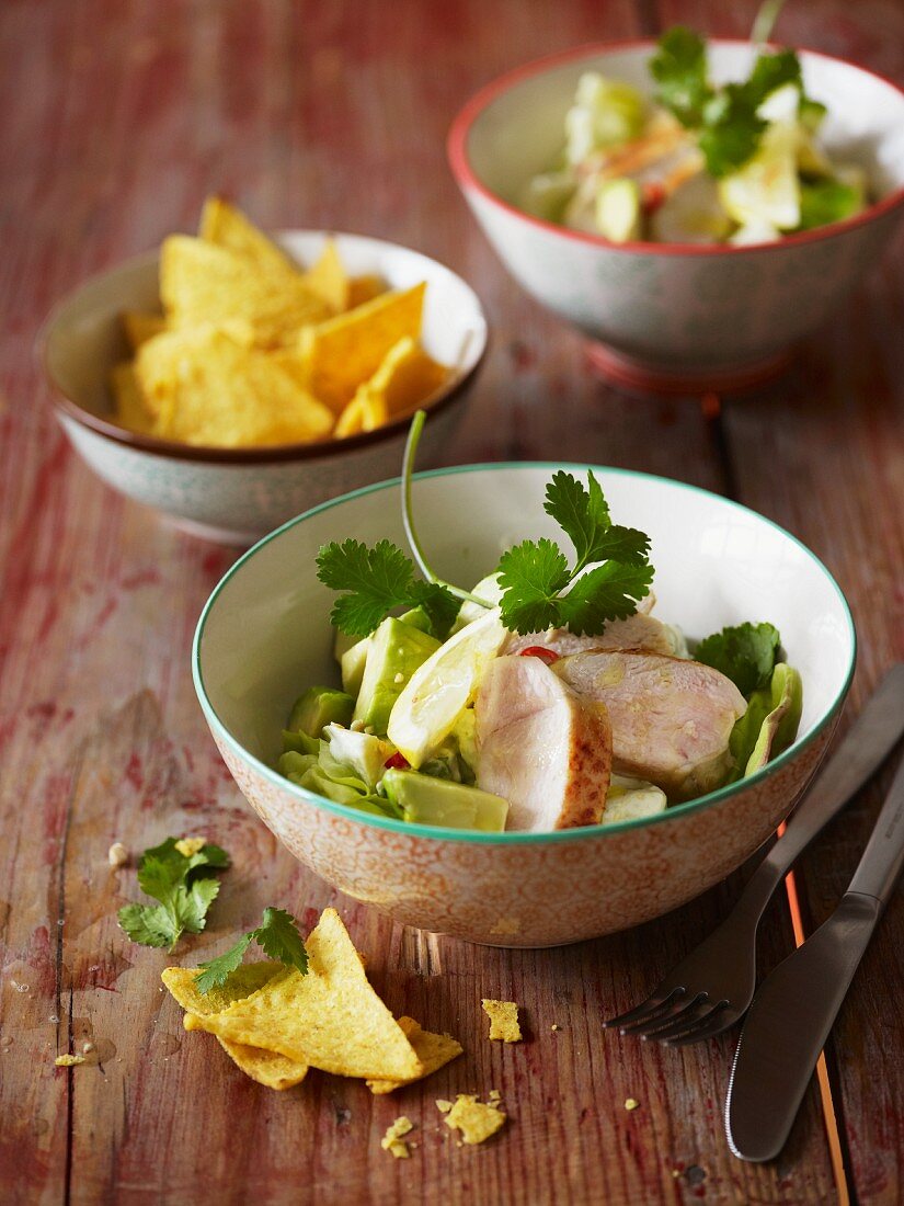 Avocado salad with chicken and coriander, and a bowl of tortilla chips