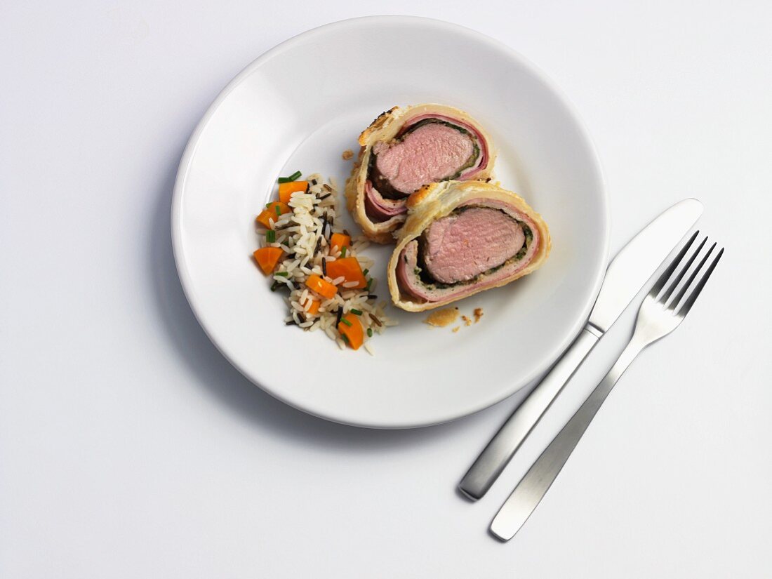 Pork fillet wrapped in puff pastry and served with rice