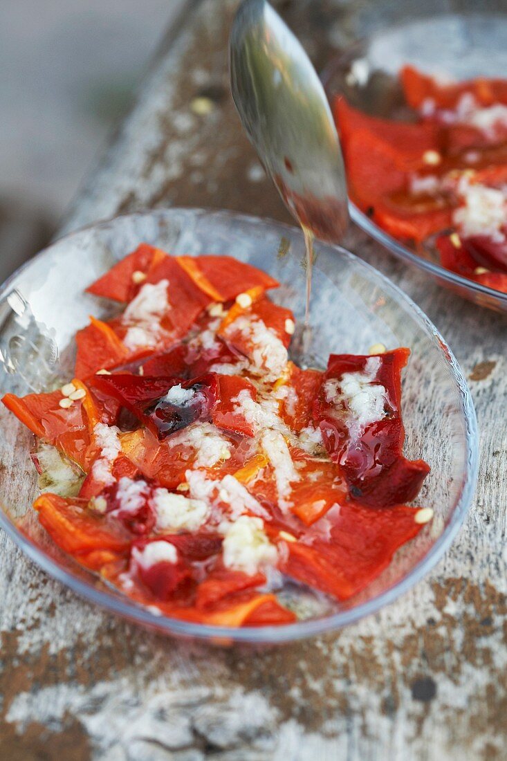 Marinated red peppers in glass bowls