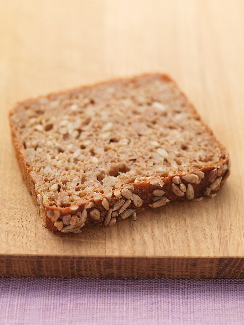 A slice of wholemeal bread on a chopping board