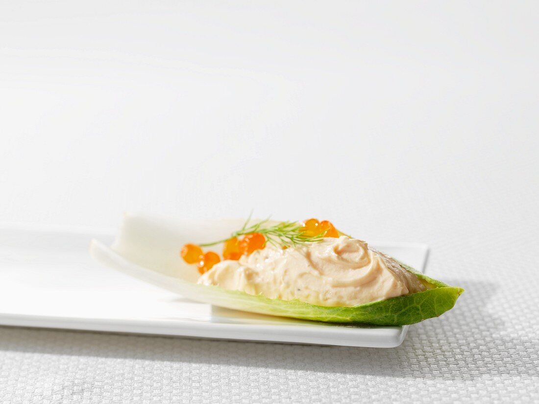 Salmon mousse with caviar on a chicory leaf